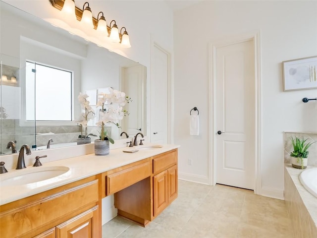 bathroom featuring a bath, double vanity, and a sink