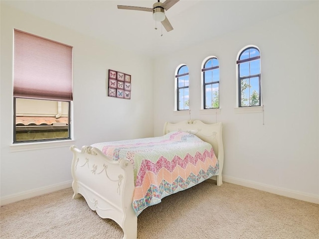 carpeted bedroom with a ceiling fan and baseboards