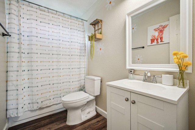 full bath with toilet, wood finished floors, a textured wall, vanity, and shower / bathtub combination with curtain