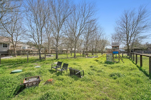 view of yard featuring a fire pit and a fenced backyard