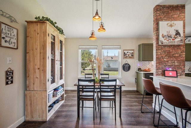 dining space featuring dark wood-style floors and baseboards