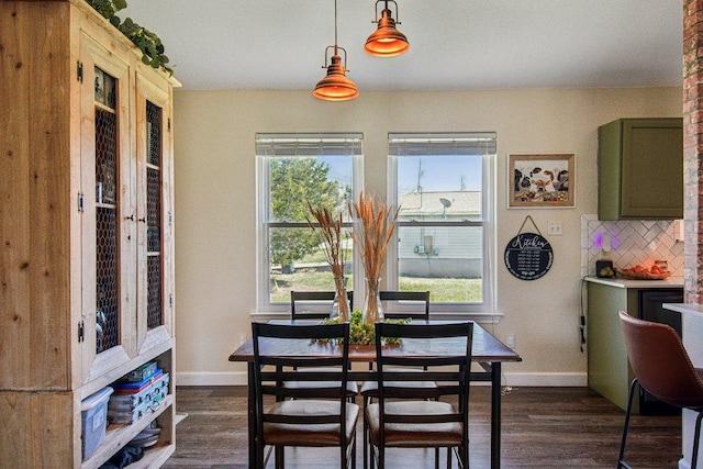 dining room featuring baseboards and dark wood-type flooring