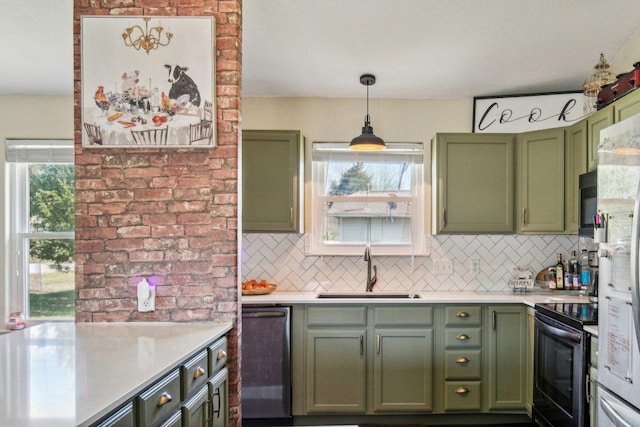 kitchen featuring green cabinets, a wealth of natural light, dishwashing machine, electric range, and a sink