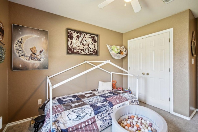 bedroom featuring a closet, baseboards, carpet, and a ceiling fan