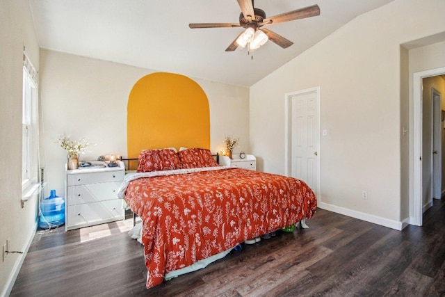 bedroom featuring a ceiling fan, vaulted ceiling, wood finished floors, and baseboards