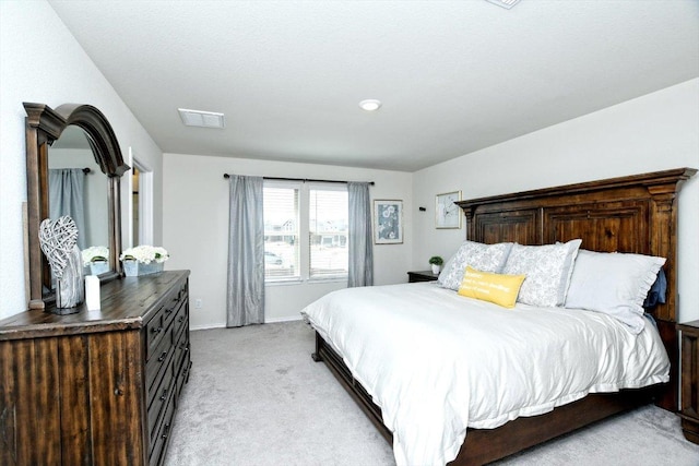 bedroom featuring visible vents, baseboards, and light colored carpet