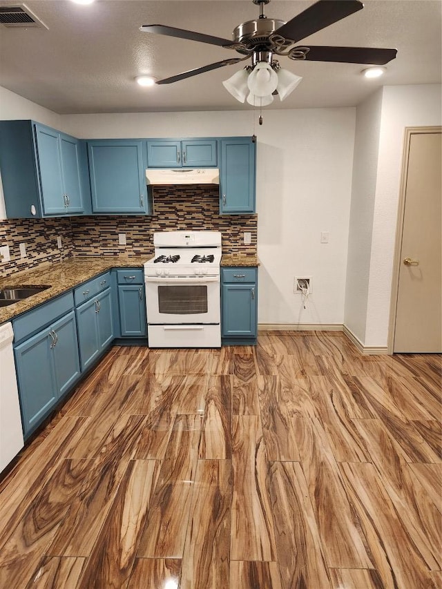 11801 Briarcreek Loop, Manor, TX 78653 - kitchen featuring white range with gas cooktop, blue cabinetry, under cabinet range hood, and backsplash