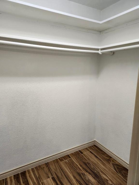 11801 Briarcreek Loop, Manor, TX 78653 - walk in closet with dark wood-type flooring
