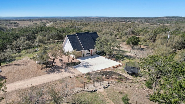 drone / aerial view with a wooded view