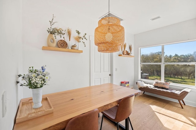 dining space with visible vents and light wood-style flooring