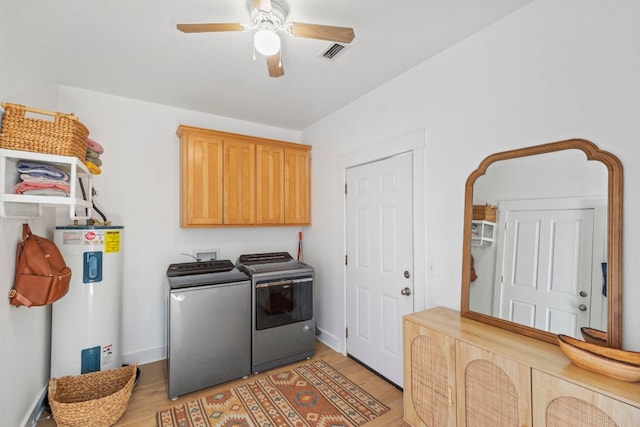 washroom featuring visible vents, cabinet space, ceiling fan, electric water heater, and washing machine and dryer