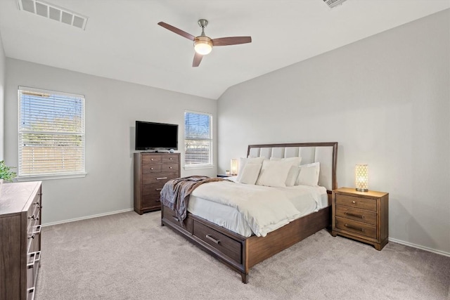 bedroom featuring visible vents, baseboards, ceiling fan, vaulted ceiling, and light colored carpet