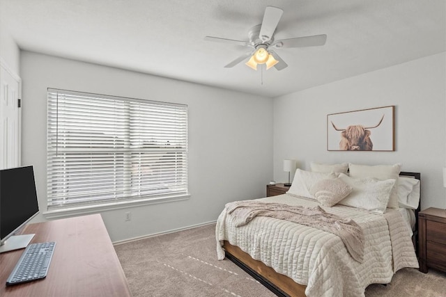 carpeted bedroom featuring baseboards, multiple windows, and a ceiling fan