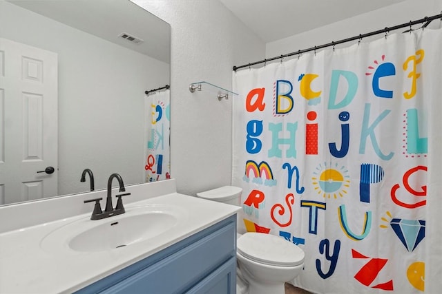 bathroom featuring visible vents, toilet, a shower with shower curtain, a textured wall, and vanity