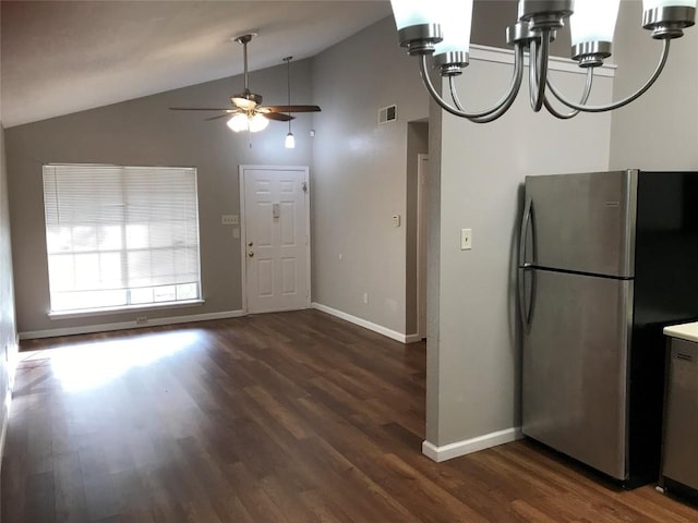 kitchen with visible vents, lofted ceiling, ceiling fan with notable chandelier, freestanding refrigerator, and wood finished floors