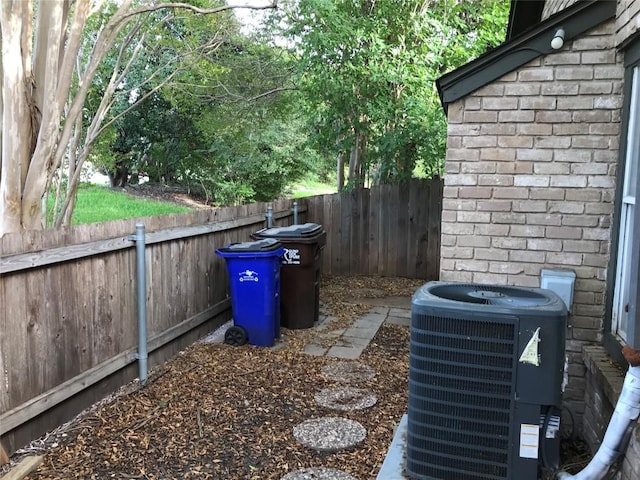 exterior space featuring a fenced backyard and central AC