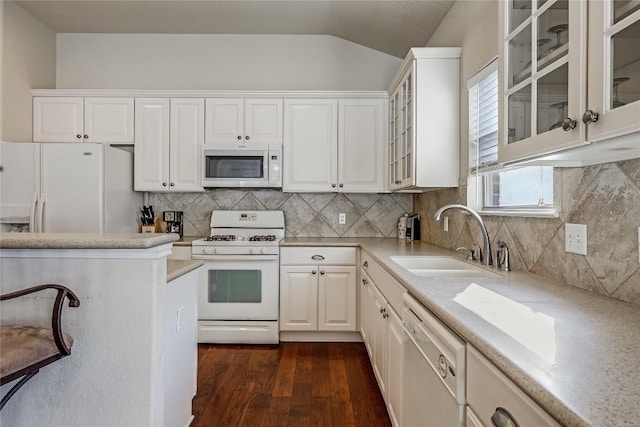 kitchen featuring dark wood-type flooring, a sink, white appliances, white cabinets, and light countertops