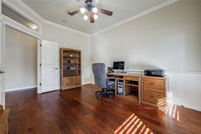 home office with wainscoting, wood finished floors, a ceiling fan, and ornamental molding