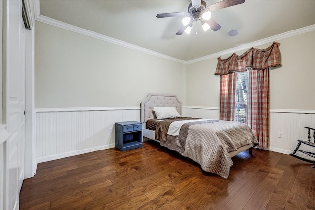 bedroom featuring a wainscoted wall, crown molding, a ceiling fan, and wood finished floors