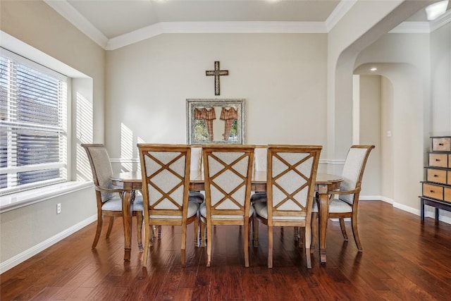 dining room with wood finished floors, baseboards, and ornamental molding