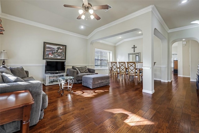 living area with arched walkways, vaulted ceiling, a ceiling fan, and hardwood / wood-style flooring