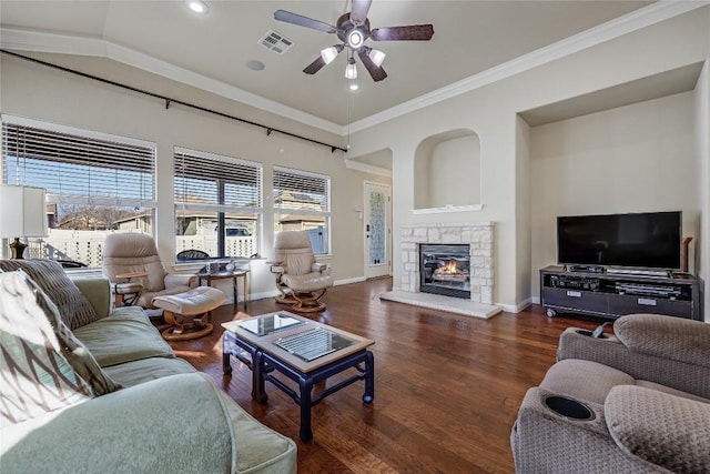 living room featuring visible vents, baseboards, wood finished floors, and a ceiling fan