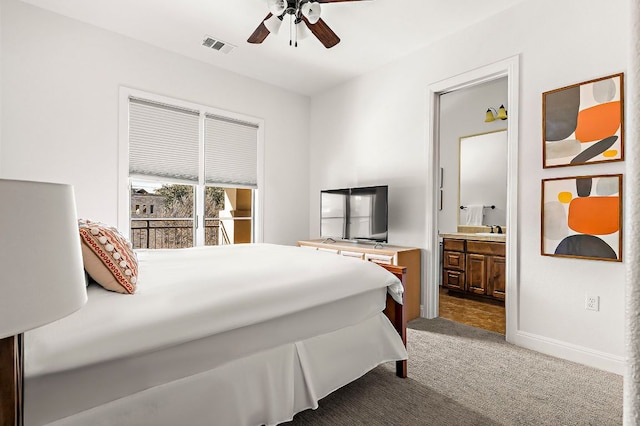 bedroom featuring a ceiling fan, visible vents, baseboards, dark colored carpet, and connected bathroom