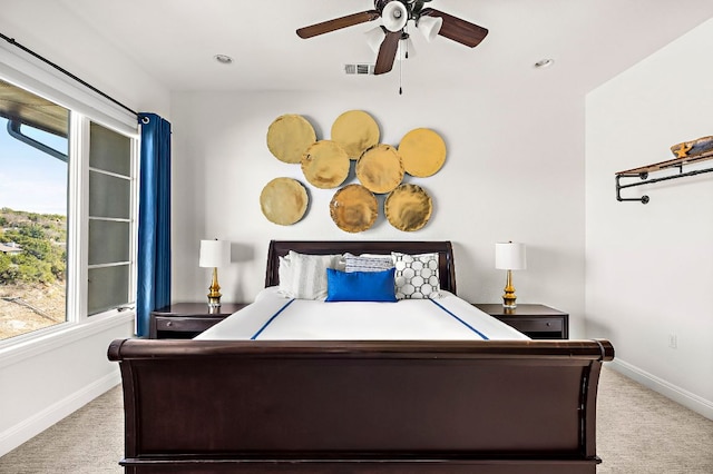 bedroom with visible vents, multiple windows, baseboards, and carpet