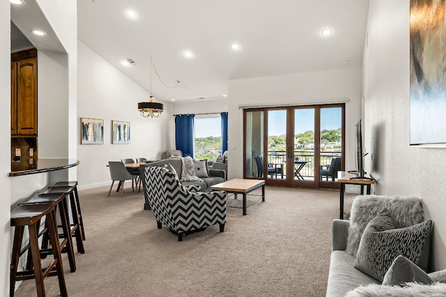 living area with recessed lighting, baseboards, light carpet, and a towering ceiling