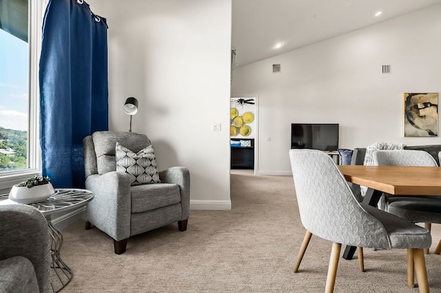 home office with light carpet, visible vents, baseboards, and vaulted ceiling