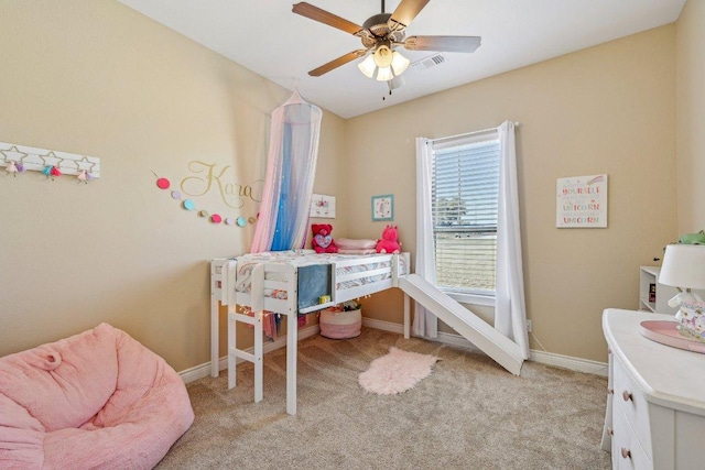 bedroom with visible vents, light colored carpet, baseboards, and ceiling fan