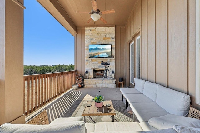 view of patio featuring an outdoor living space with a fireplace and ceiling fan