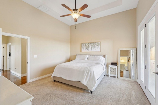 bedroom with baseboards, a high ceiling, carpet floors, and a ceiling fan