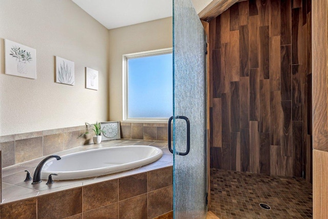 bathroom featuring a garden tub and a stall shower