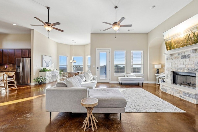 living room featuring finished concrete floors, a wealth of natural light, and ceiling fan