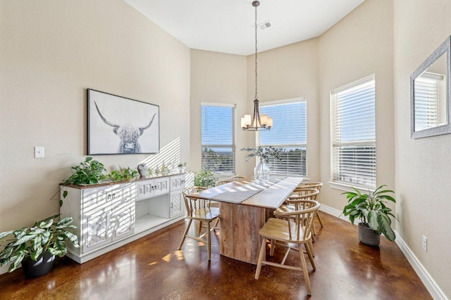 dining area with visible vents, baseboards, concrete floors, and an inviting chandelier