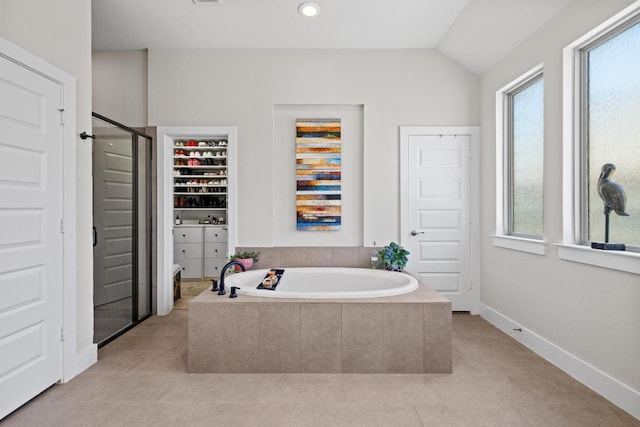 full bath featuring tile patterned flooring, a garden tub, a stall shower, and vaulted ceiling