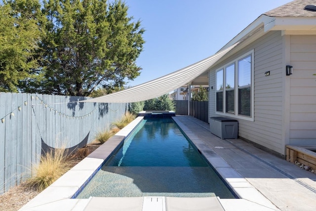 view of pool featuring a patio, a pool with connected hot tub, and a fenced backyard