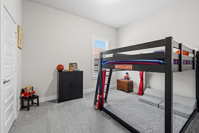 carpeted bedroom featuring baseboards