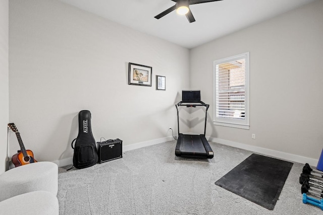 exercise area featuring a ceiling fan and baseboards