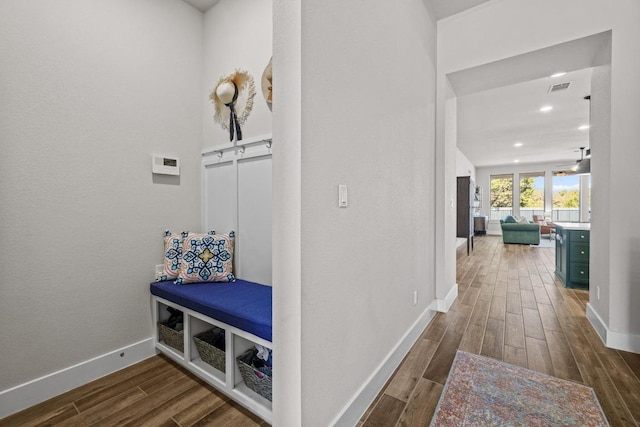 hall with visible vents, recessed lighting, baseboards, and wood tiled floor