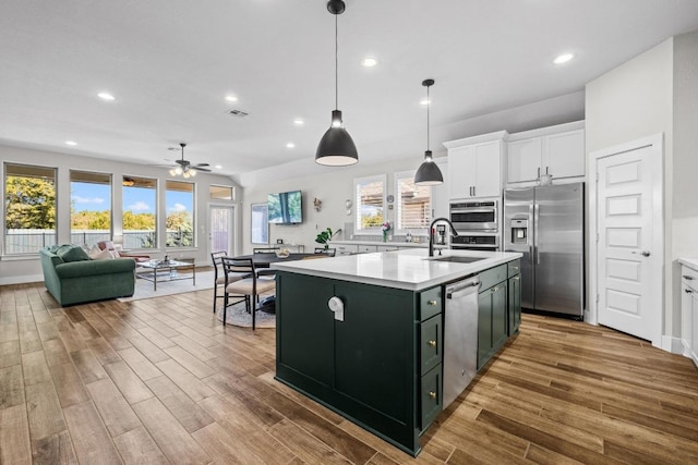 kitchen featuring white cabinetry, light countertops, a sink, and stainless steel appliances