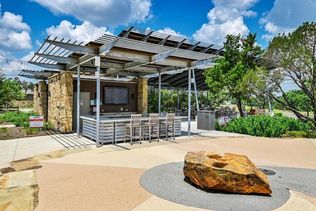 view of patio / terrace featuring outdoor dry bar and a pergola