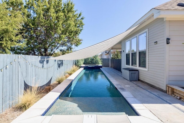 view of swimming pool with a patio, a fenced backyard, and a pool with connected hot tub