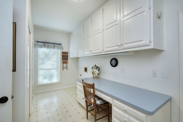 office with baseboards, light floors, and built in study area