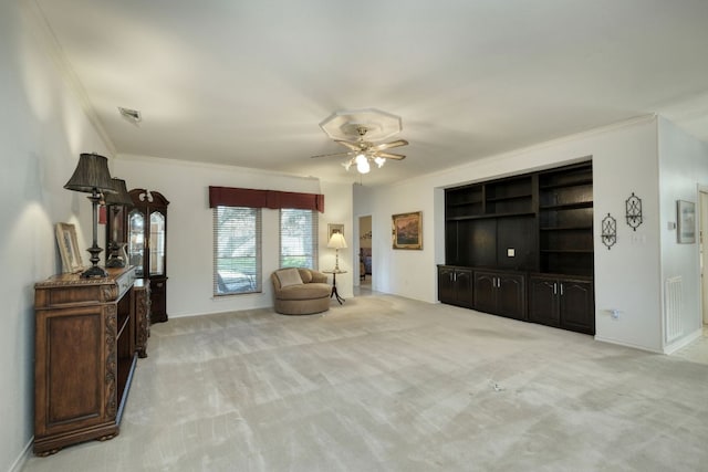 sitting room featuring crown molding, carpet, visible vents, and ceiling fan