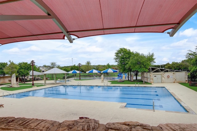 pool featuring a gazebo, a patio, and fence