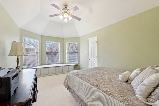 bedroom with a ceiling fan, vaulted ceiling, and carpet