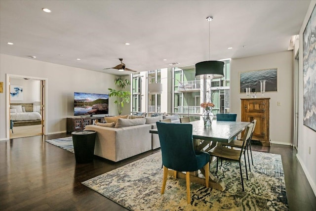 dining area featuring a wall of windows, baseboards, recessed lighting, dark wood-style flooring, and ceiling fan