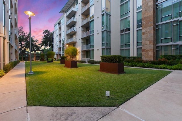 view of home's community featuring a lawn